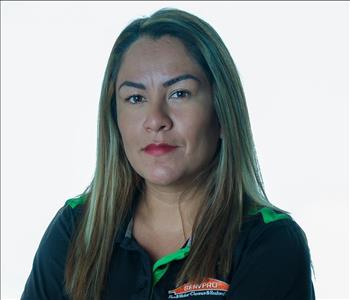Woman in SERVPRO uniform posing for a picture on a white background