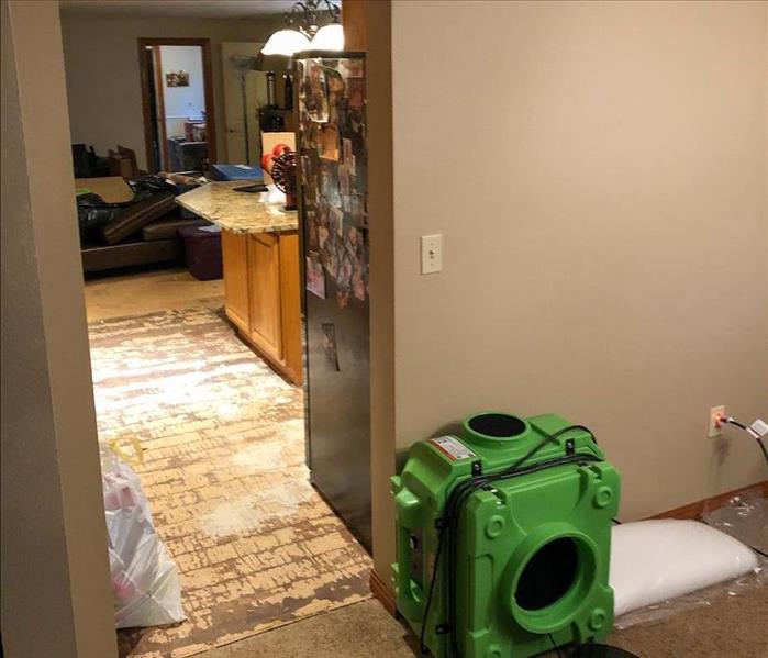 Air mover set up in the kitchen of a San Diego home to dry the water damage on the floor
