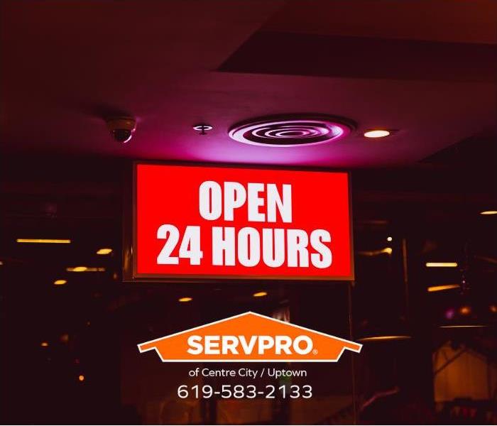 A sign reading, “Open 24-Hours,” is shown.