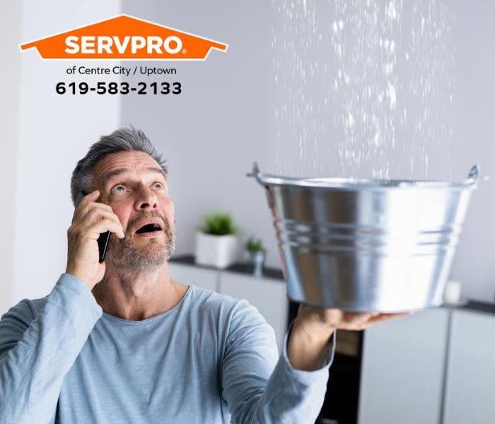 A person calls for professional help for a water damage emergency.